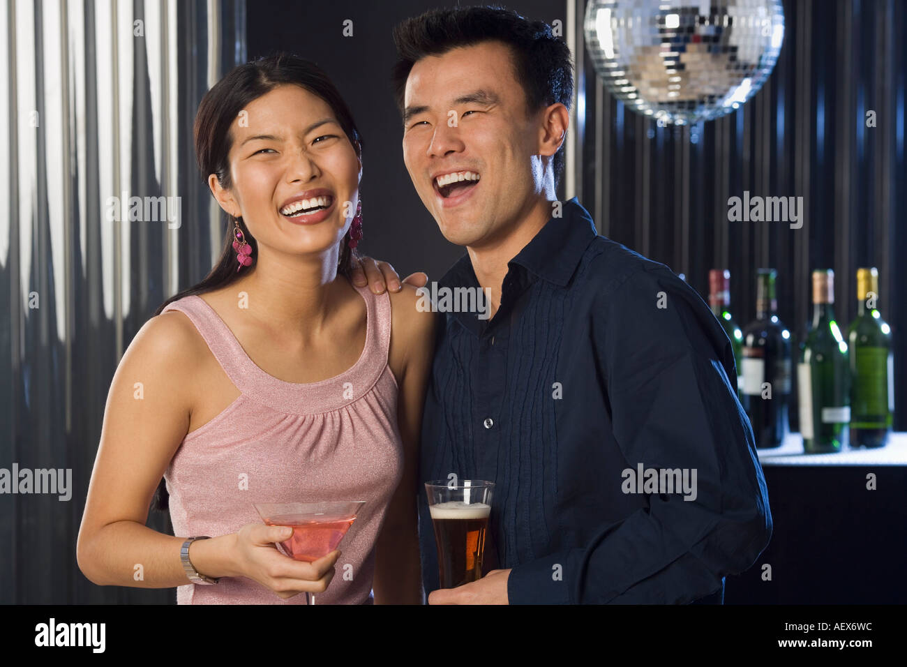 Couple having drinks in a bar Stock Photo