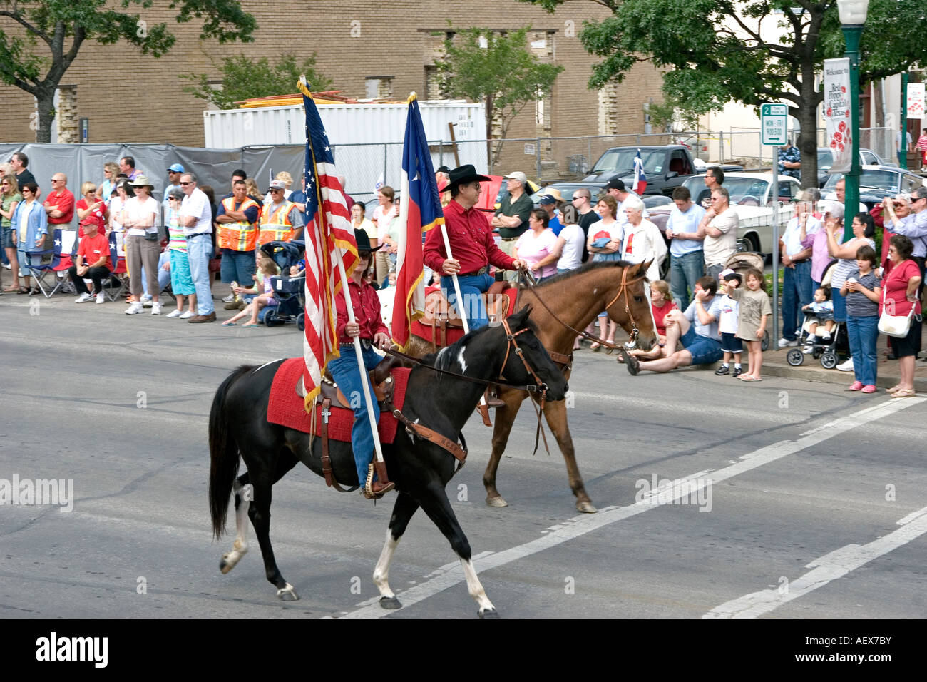 Horse mounted man and woman color guard in street festival parade Stock Photo