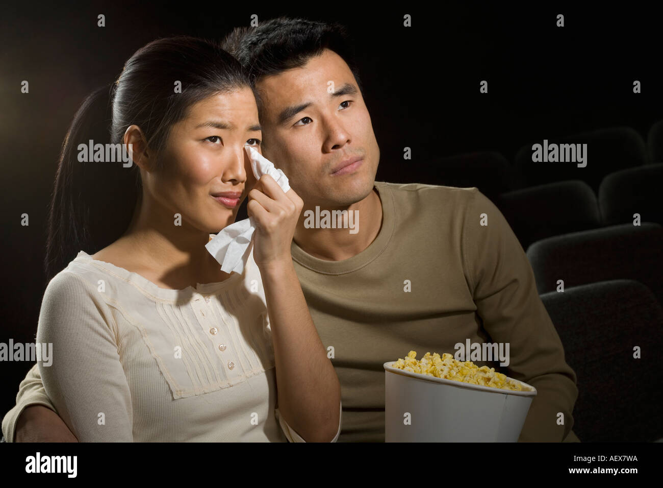 Couple watching a sad movie Stock Photo
