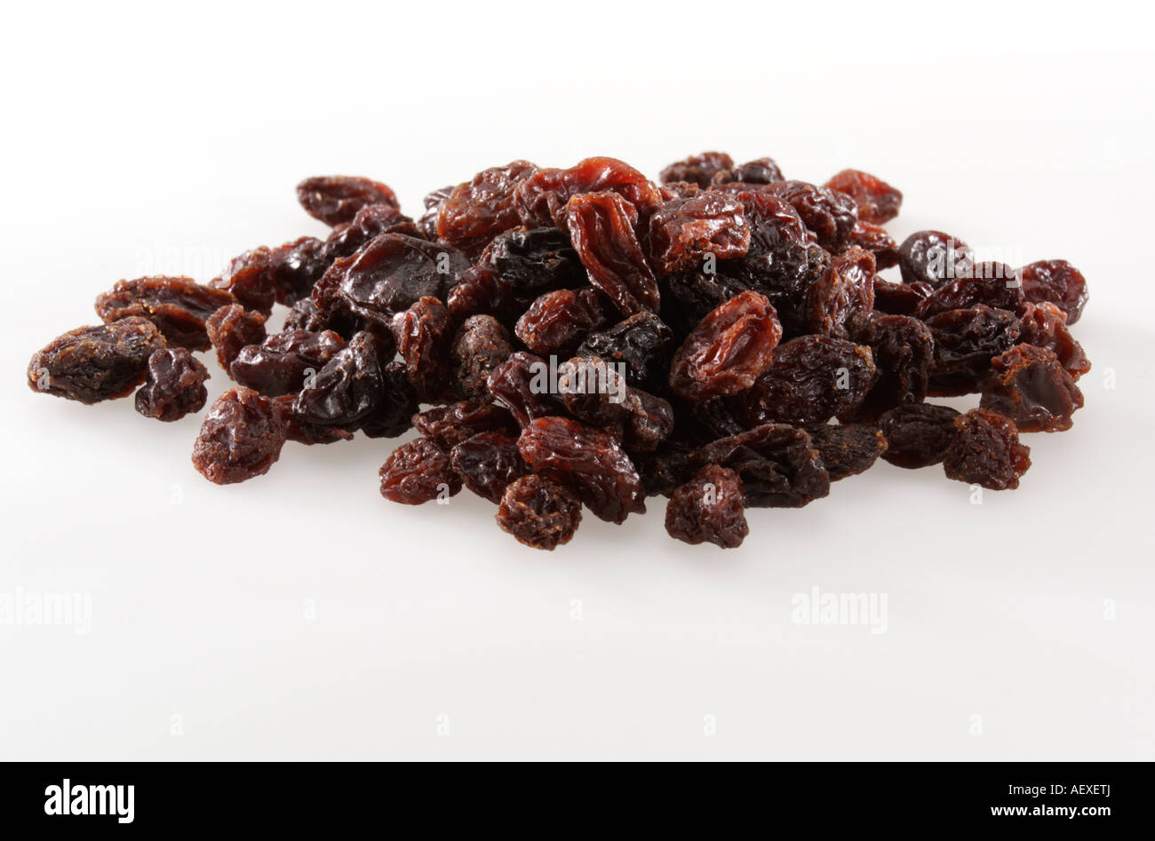 Pile of raisins on a white background Stock Photo - Alamy