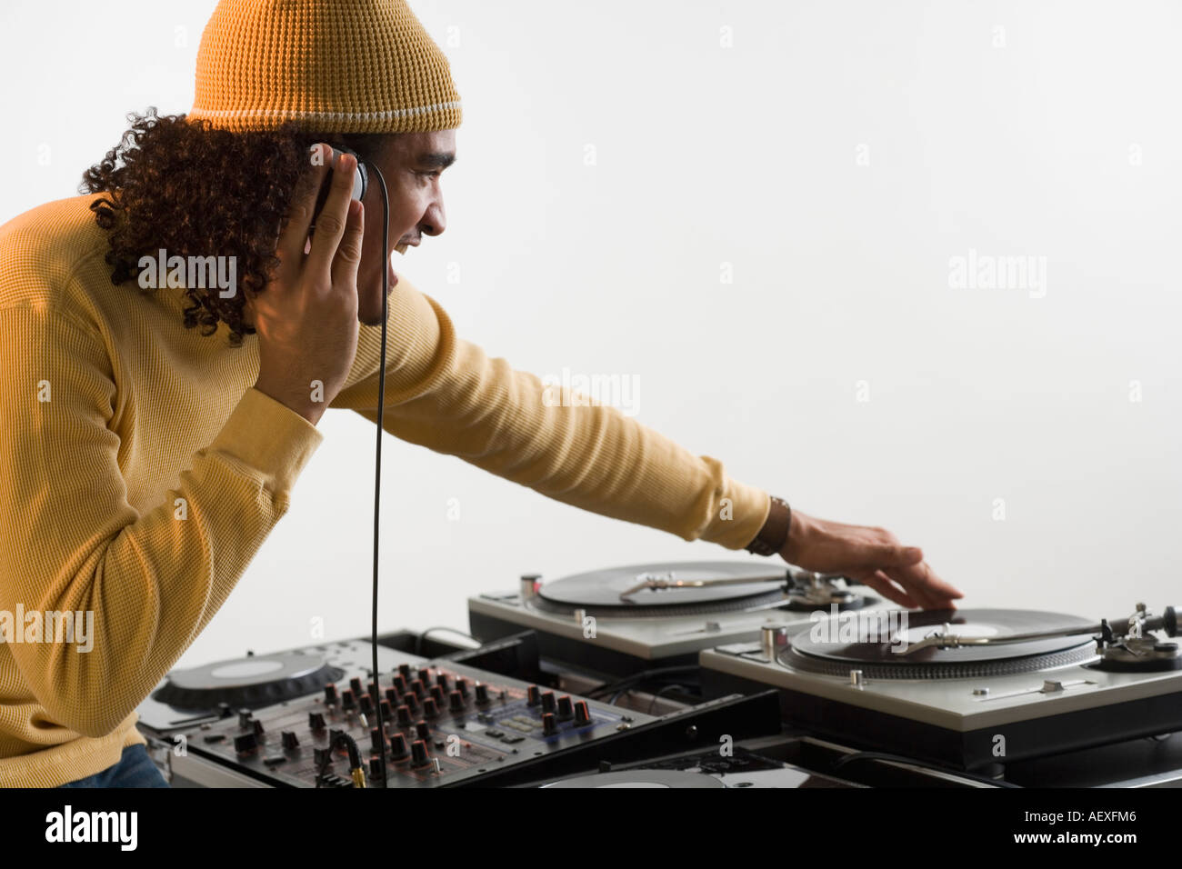 DJ working at music mixing board Stock Photo