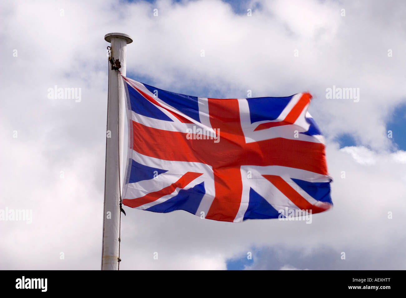 Union Jack flag flying against a cloudy sky Stock Photo - Alamy