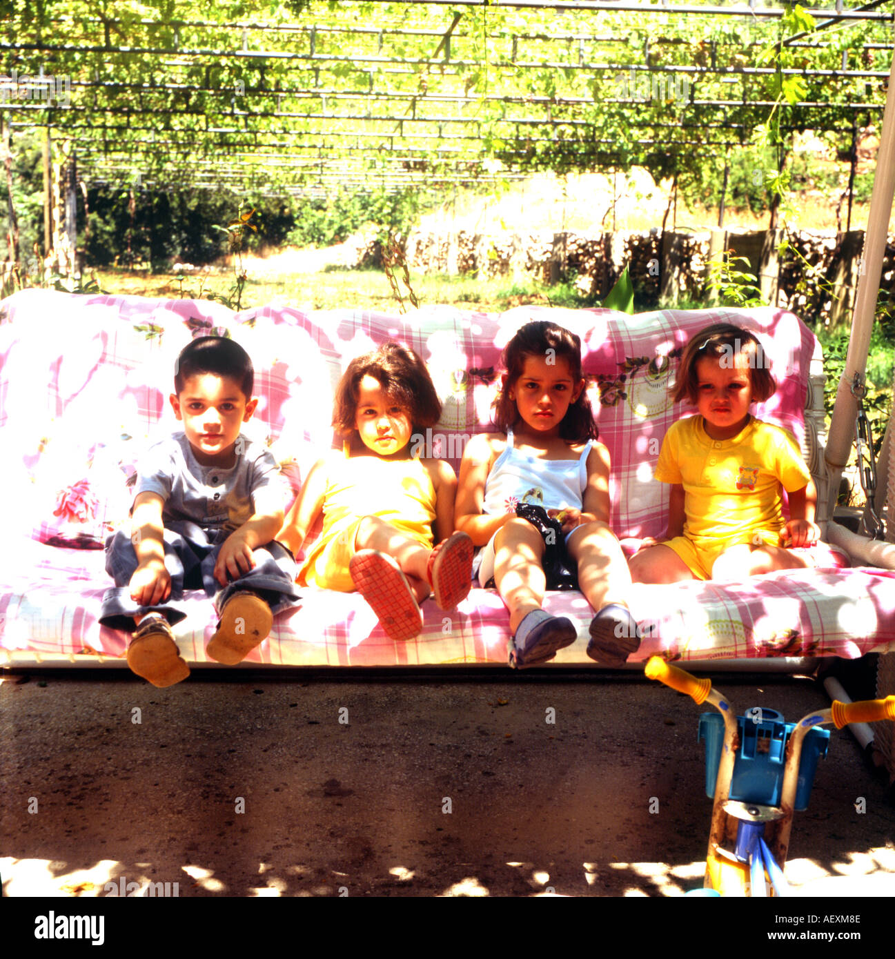 children sitting on swing lebanon Stock Photo Alamy