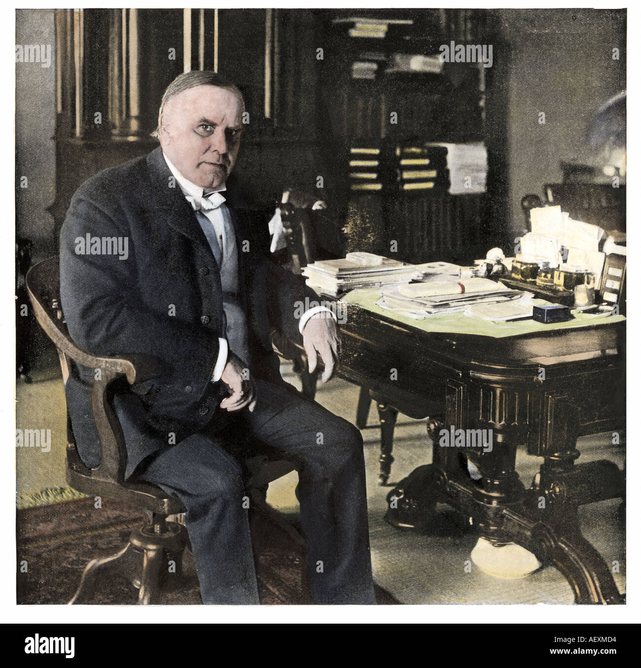 US President William McKinley at his desk from a photograph taken June 7 1898. Hand-colored halftone of a photograph Stock Photo