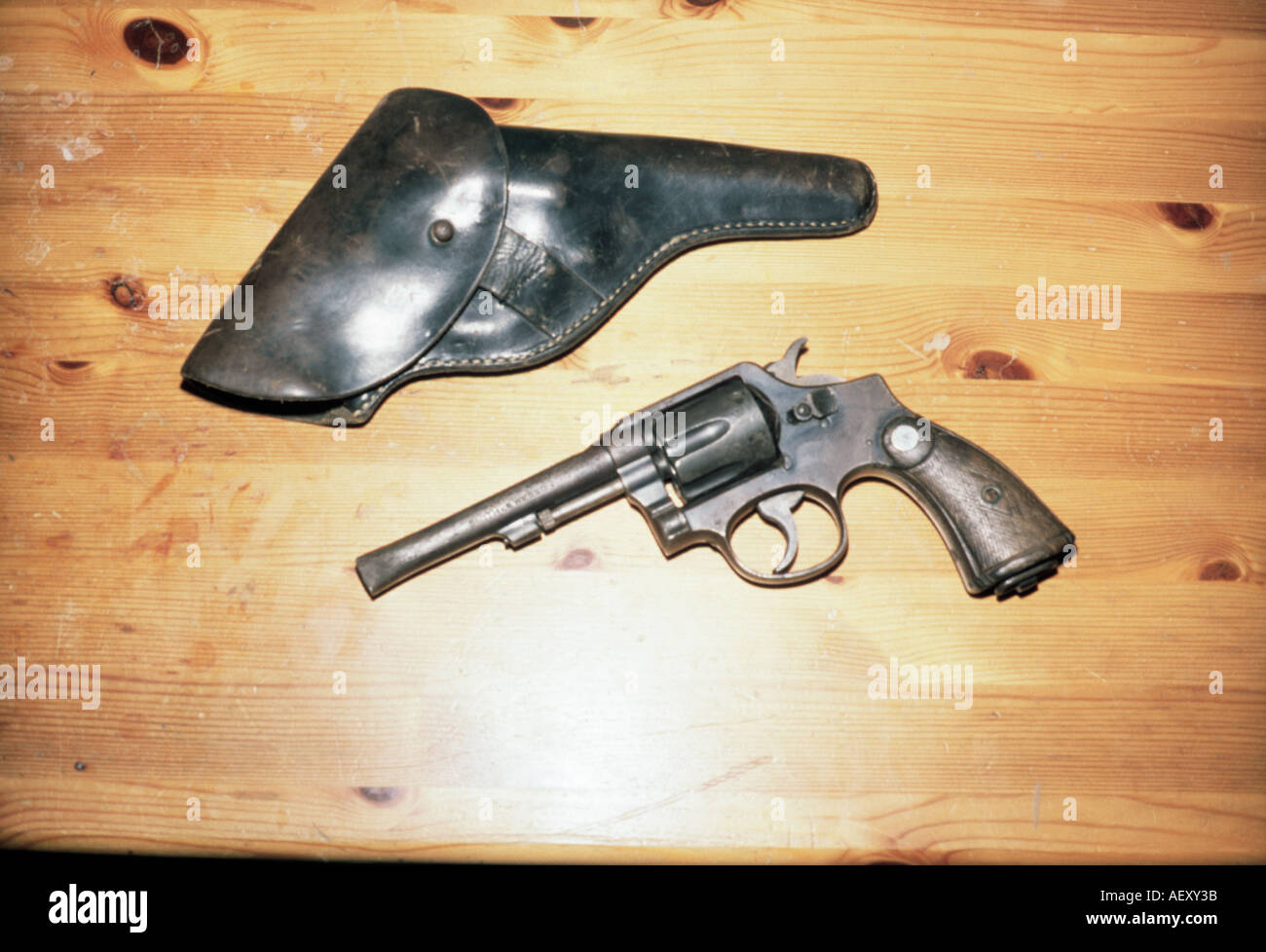 A colt and a its holster lying on a wooden table  Stock Photo