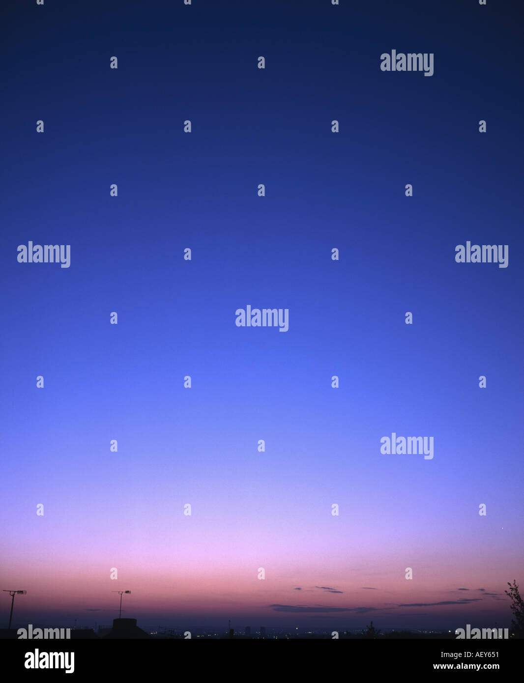 Pink and blue evening sky with silhouettes of buildings Stock Photo