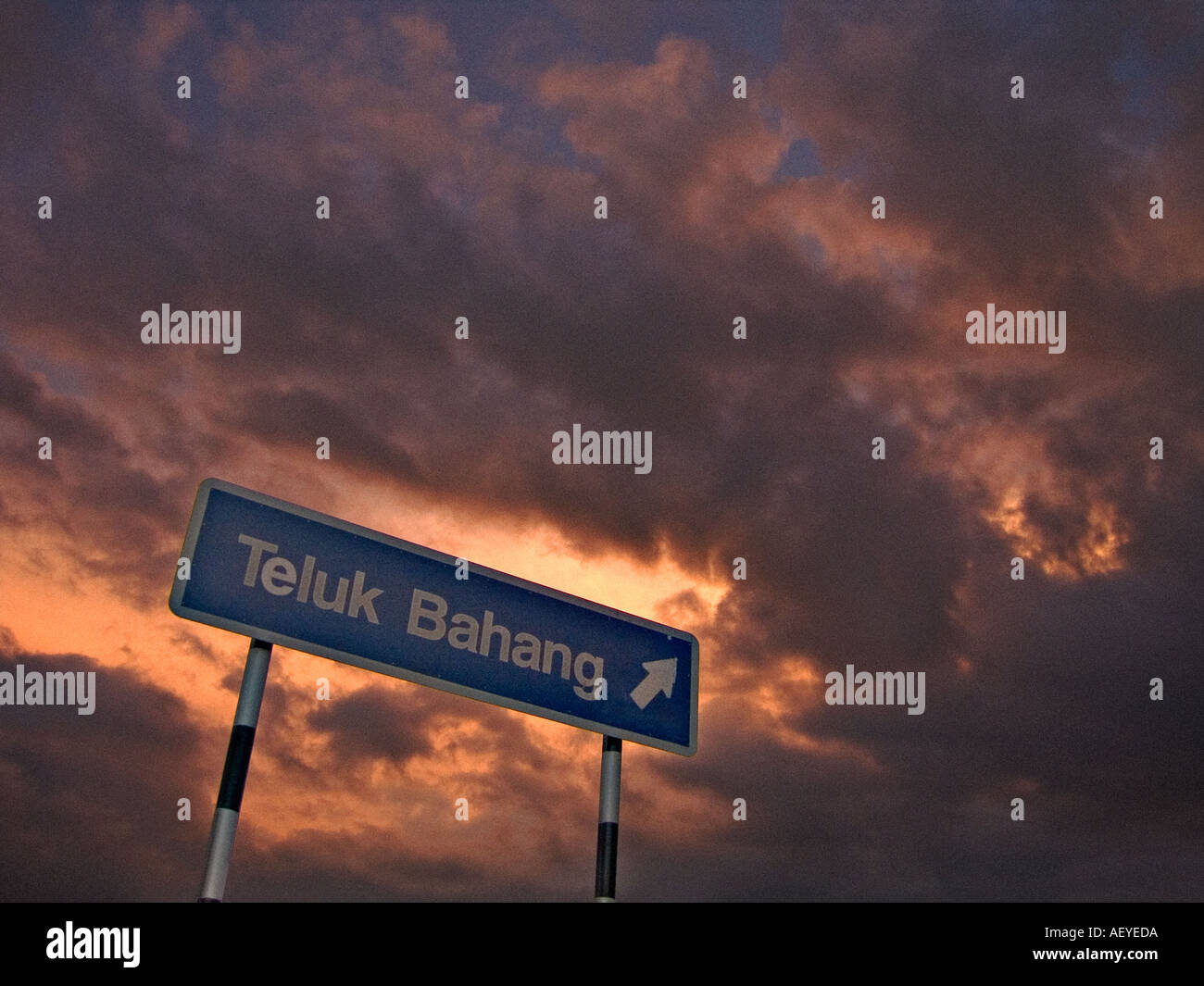 Street signage against sunset sky Stock Photo - Alamy