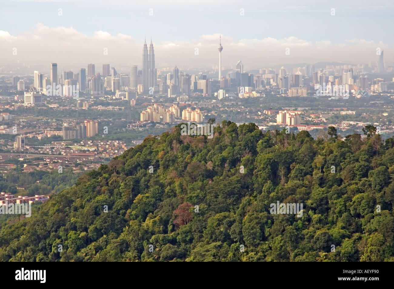 Natural vs Concrete Jungle a view of Kuala Lumpur from Bukit Tabur quartz ridge Stock Photo
