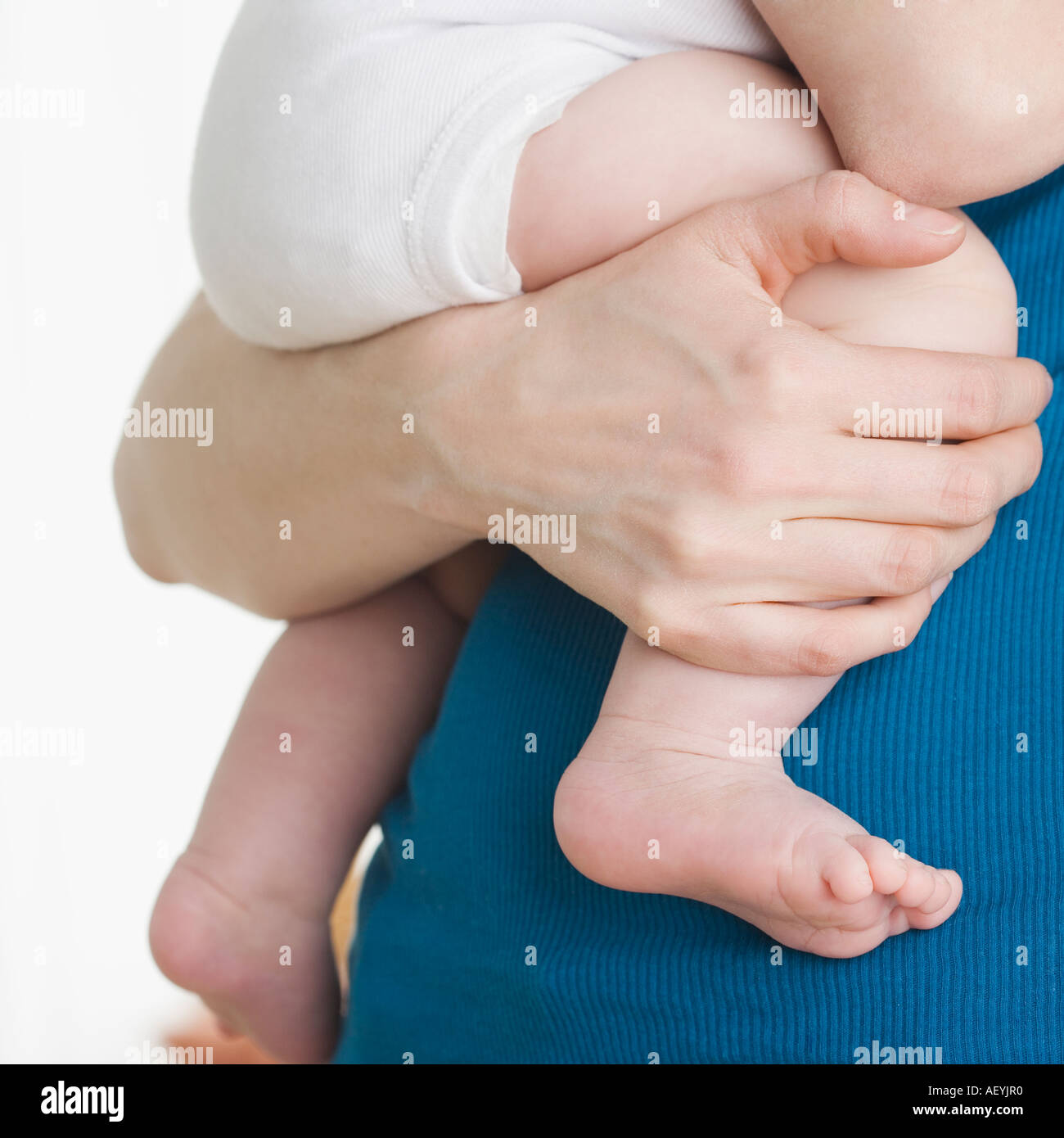 Close up of baby s legs being held by mother Stock Photo Alamy
