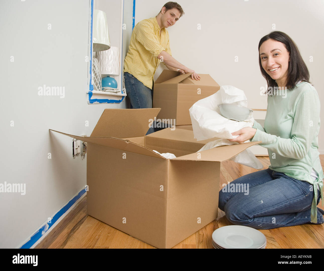 Couple unpacking boxes in new house Stock Photo - Alamy