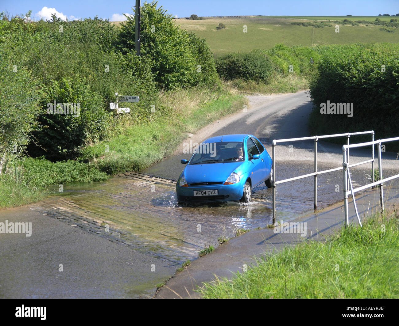 Car driving through a reiver forde in Dorset Stock Photo