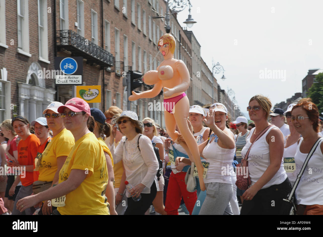 Inflatable doll being sported by some participants in women's mini marathon, Dublin City, June 2006 Stock Photo