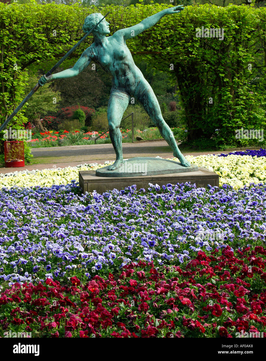 sculpture spewer in the middle of coloured flowers in Grugapark Essen