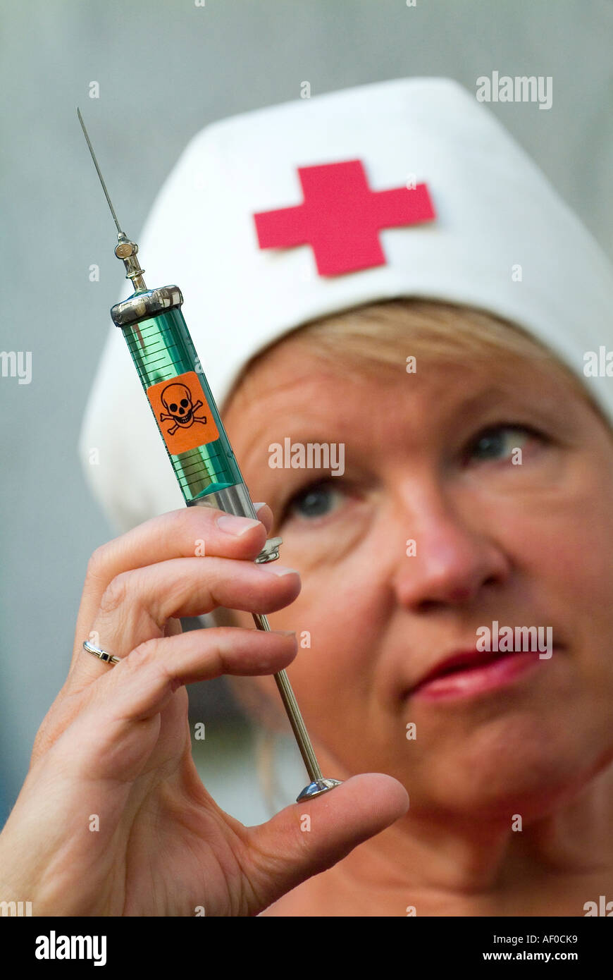 injection shot syringe filled with poison in hand of a nurse Stock