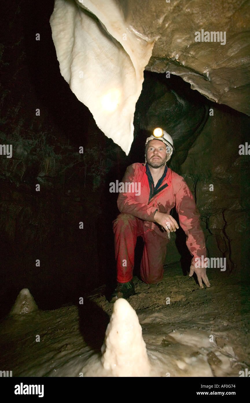 a male caver inspects formations in the newly discovered Notts II cave ...