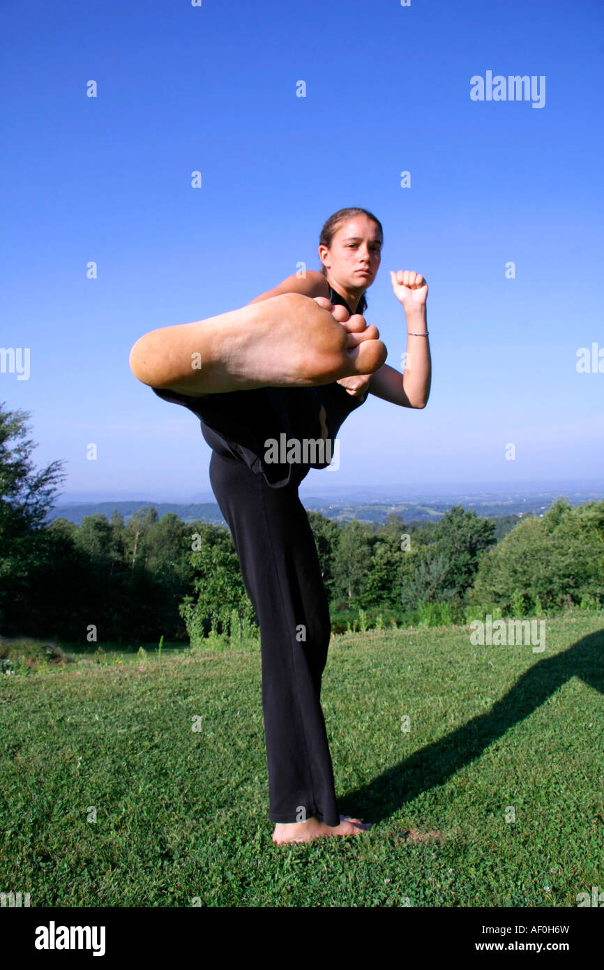 sole kick attractive young woman practising self defense Stock Photo