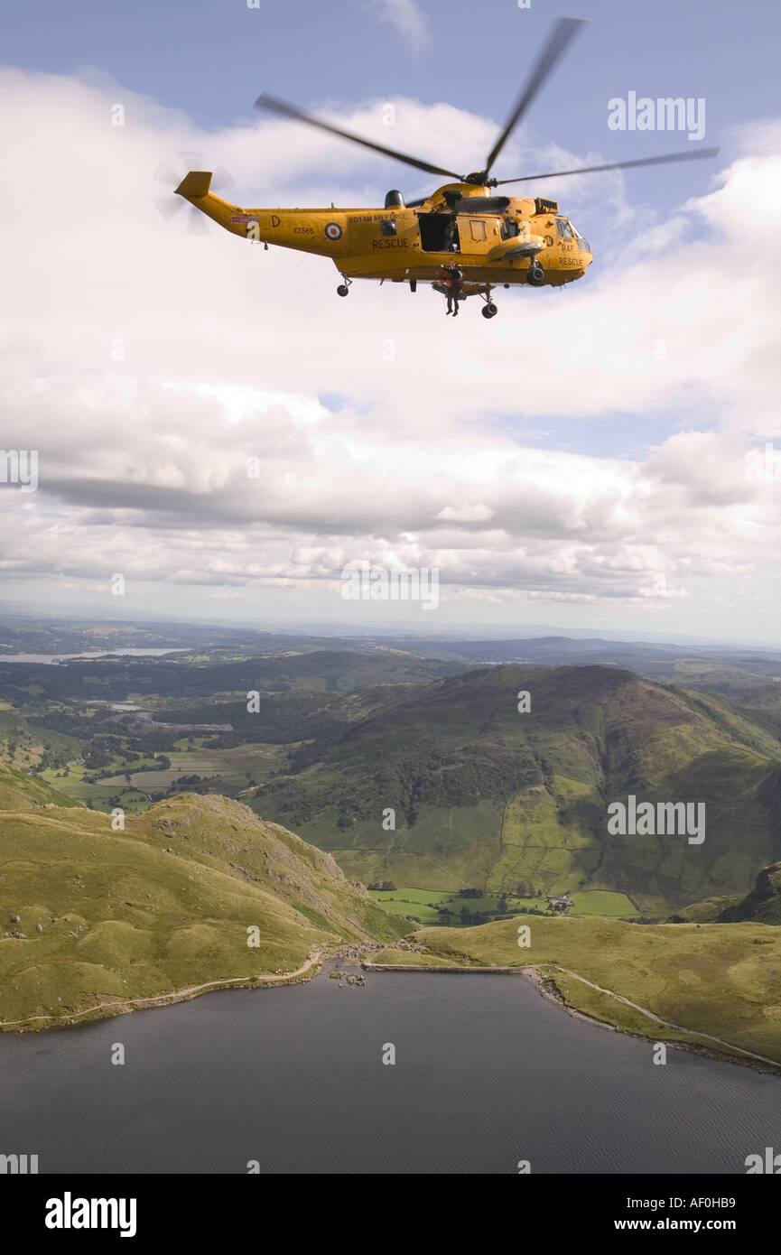 an RAF sea king helicopter whinch up an injured climber with a ...