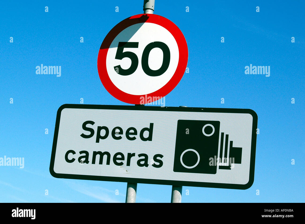 Speed limit road sign warning of speed cameras Stock Photo