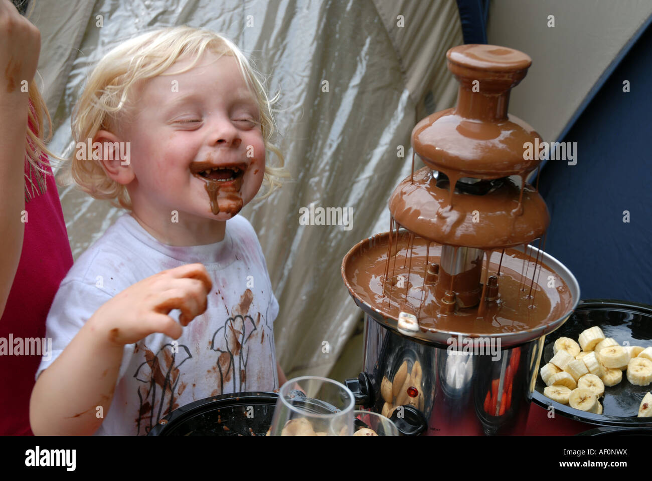 Wilf eating chocolate from chocolate fountain Stock Photo