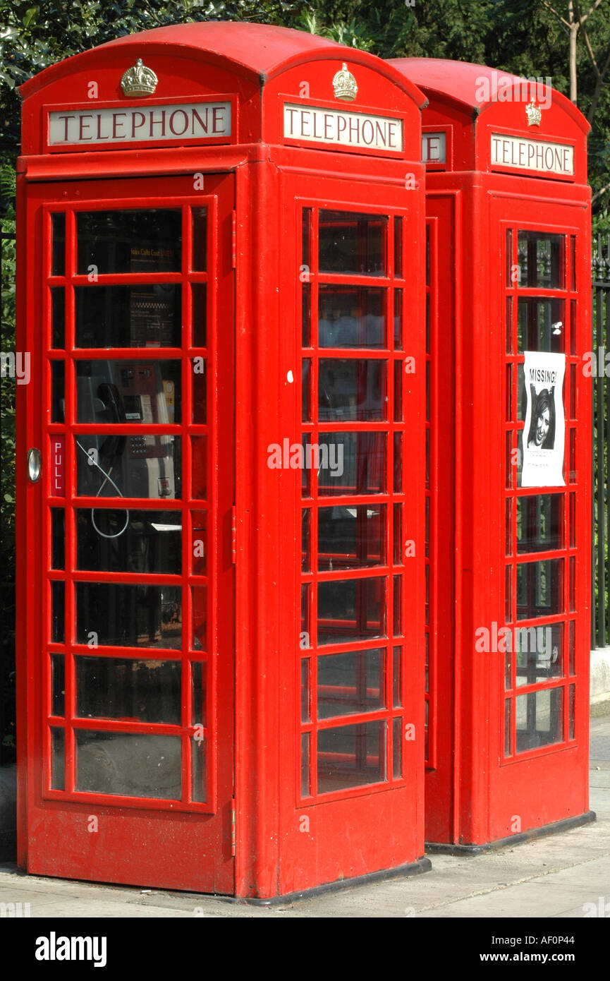 Two traditional red telephone boxes one with a missing person poster on it Russell Square London England Stock Photo