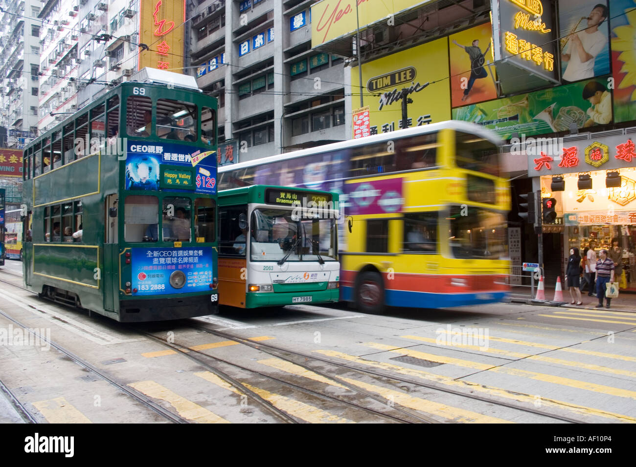Two buses and a tram Causeway Bay Hong Kong. Transportation around Hong Kong  can have a decisively colonial feel Stock Photo - Alamy