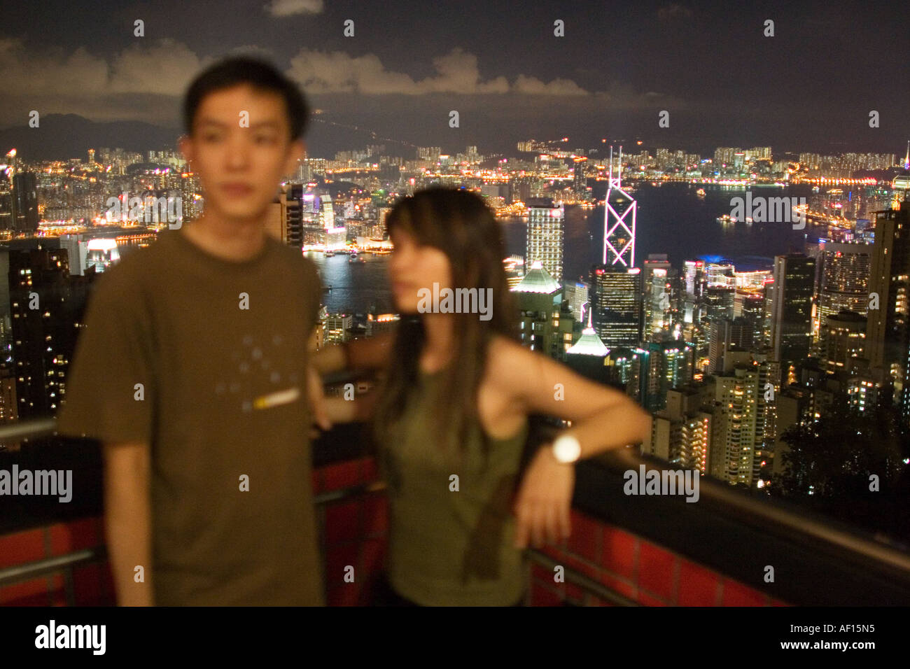 Chinese tourists have their picture taken over Hong Kong Harbour from Victoria Peak viewing platform. Stock Photo