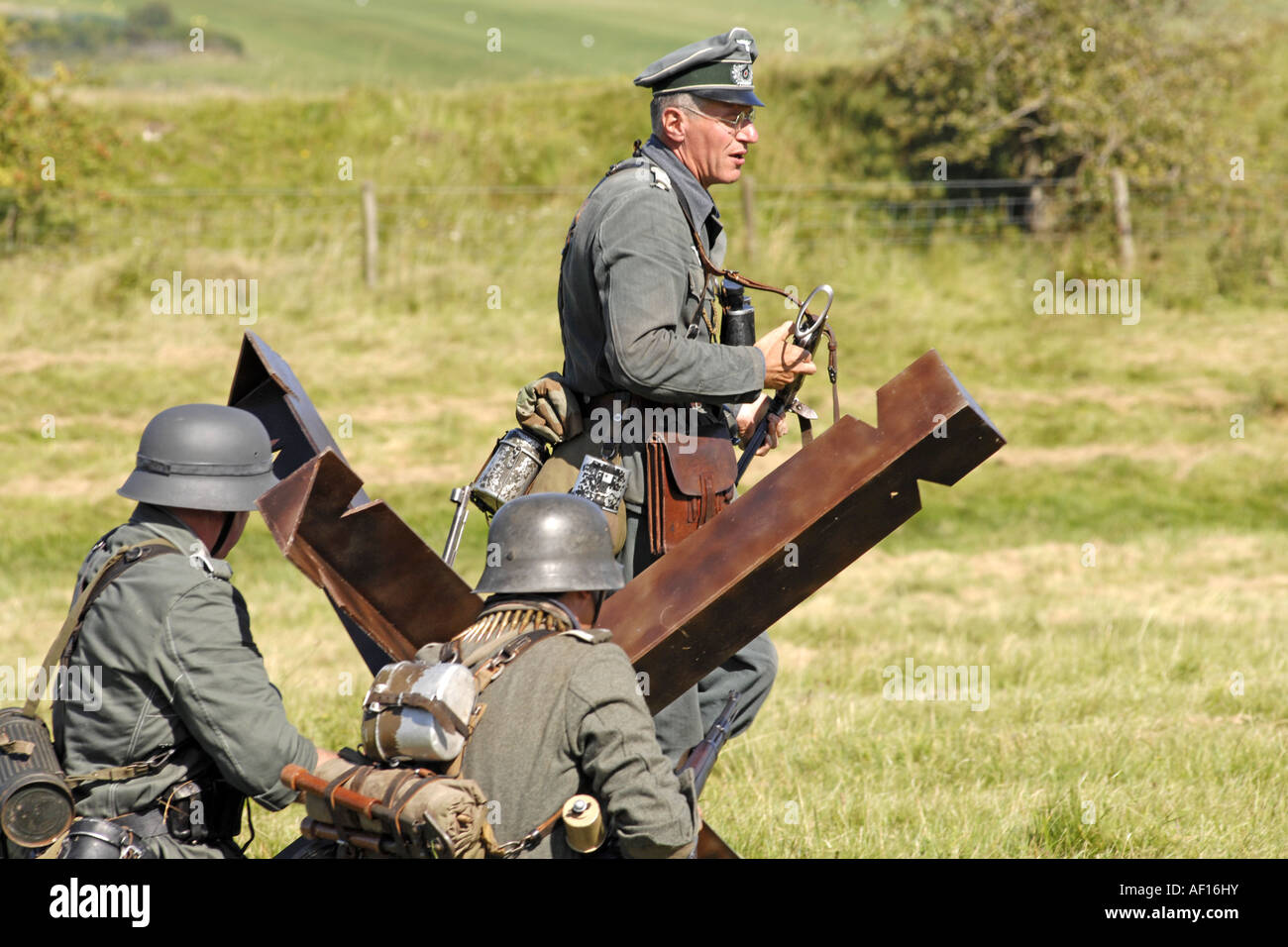 Men in a re enactment group dressed as German Army Infantry soldiers fighting a mock battle Stock Photo