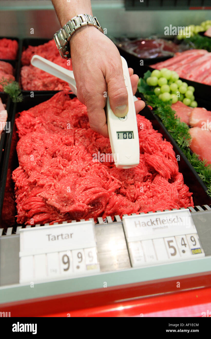 Food quality control Temperature measurement at a butcher s shop in a supermarket Stock Photo