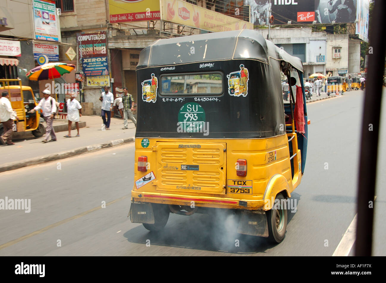 Rickshaw driver on dusty street india hires stock photography and