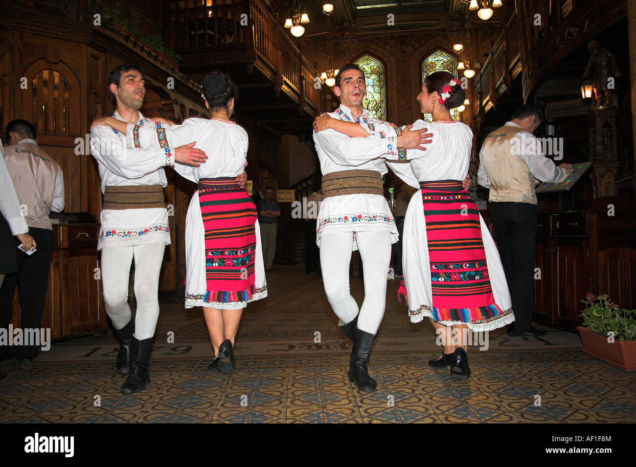 Dancers in national costume, Caru cu Bere Restaurant, Str Stavropoleos, Bucharest, Romania Stock Photo