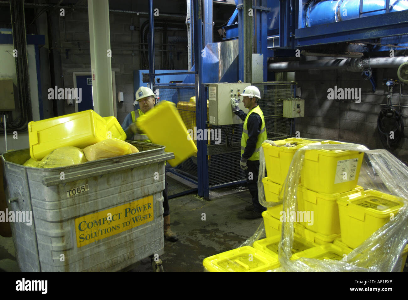 Loading toxic waste into bins prior to entering the gasification plant at Compact Power in