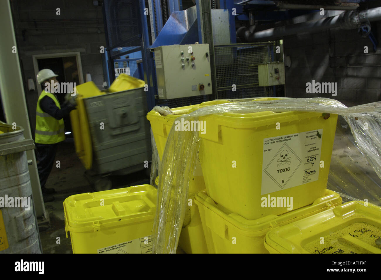 Loading toxic waste into bins prior to entering the gasification plant at Compact Power in