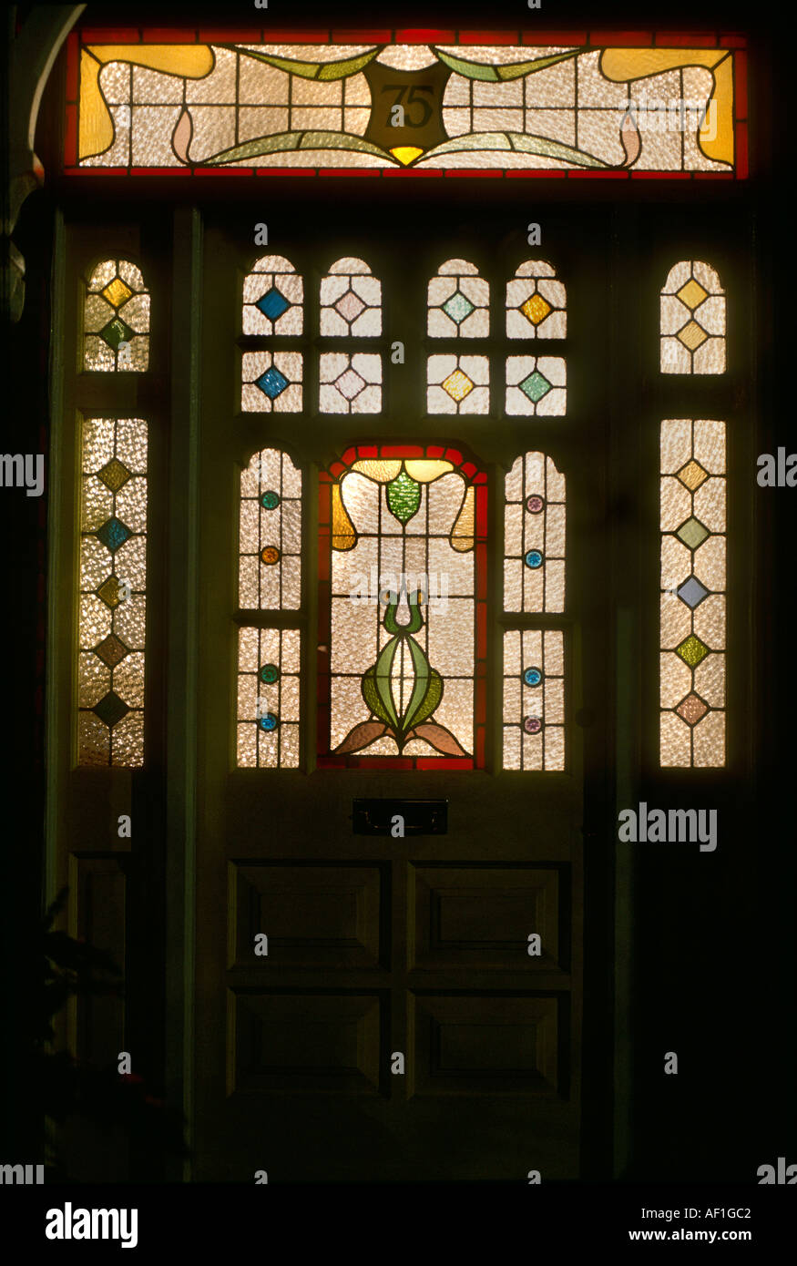 Stained Glass front door at night British Housing London Stock Photo