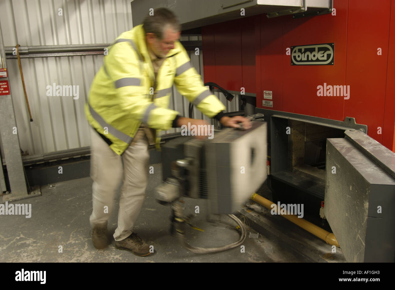 Engineer installing a 300kw biomass boiler at the Eden Project Cornwall England Stock Photo