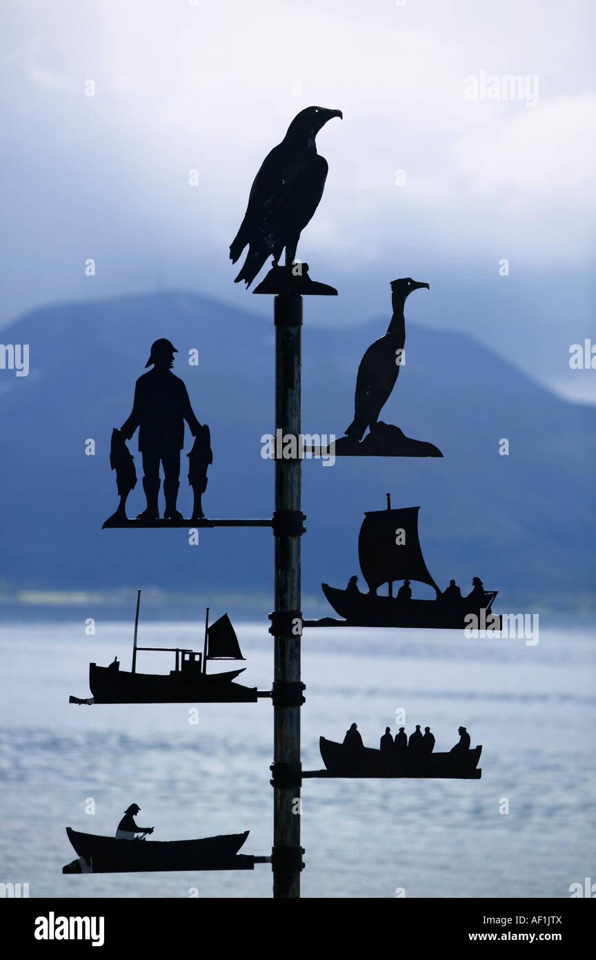 Metal artwork showing birds a fisherman and fishing boats Stock Photo