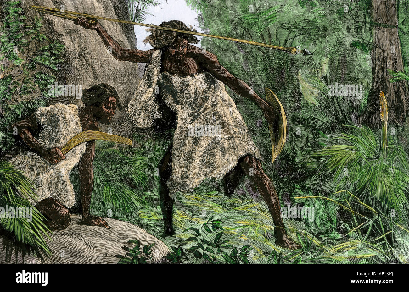 Aborigines hunting with an atlatl boomerang in an Australian forest 1800s. Hand-colored woodcut Stock Photo