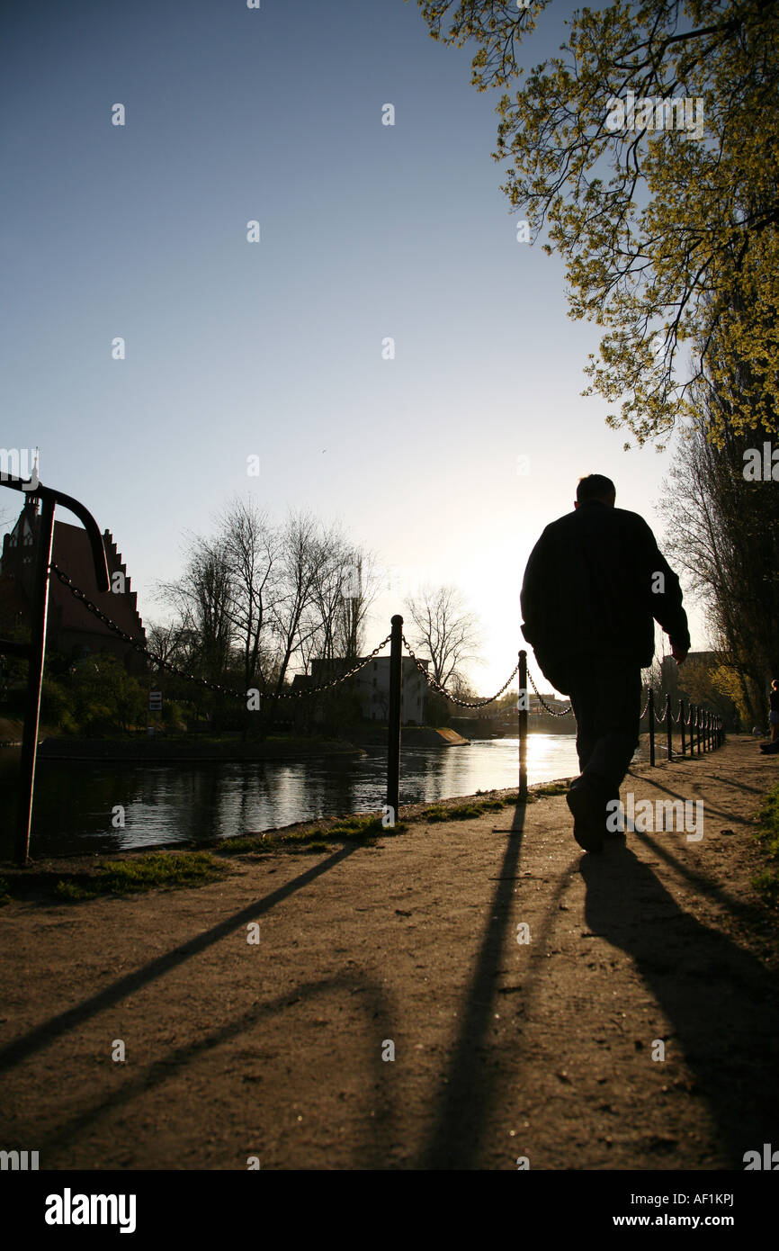 Man walking on banks of river Brda Bydgoszcz Poland Stock Photo