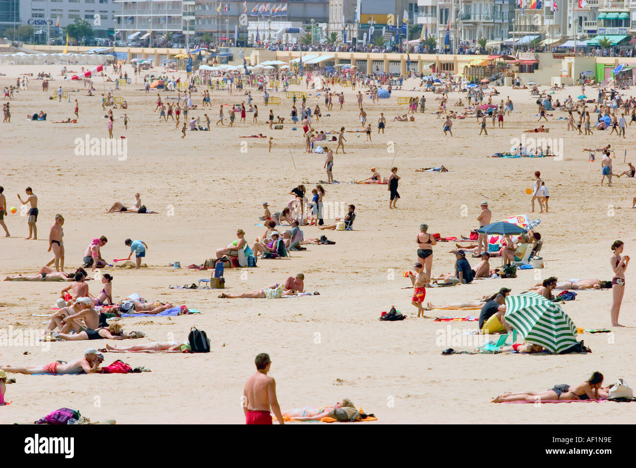 people on a white sandy beach sun tanning and enjoying themselves sables d olonne france beach Stock Photo