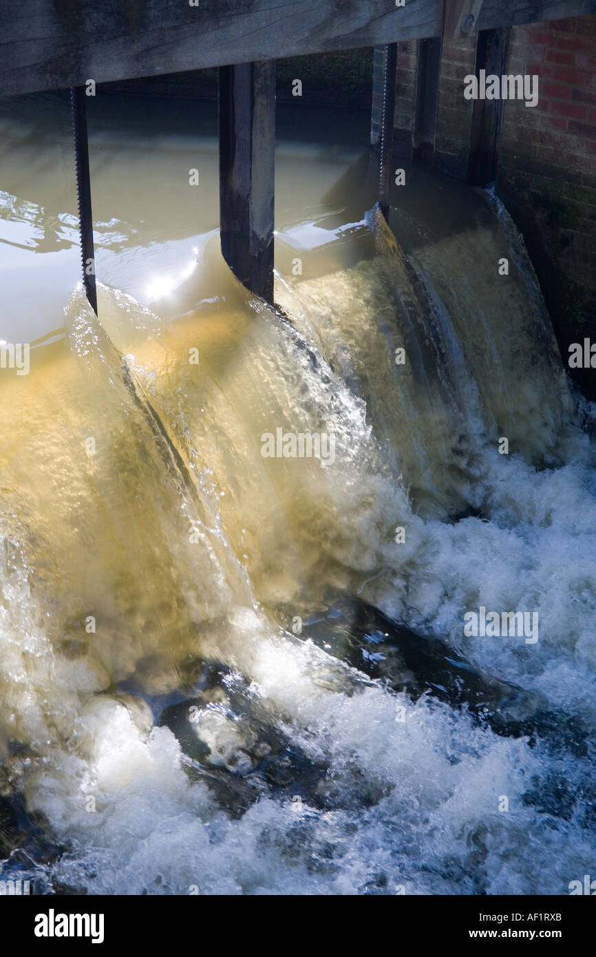 Water pouring over the weir at Cobham Mill on the River Mole, Cobham, Surrey Stock Photo