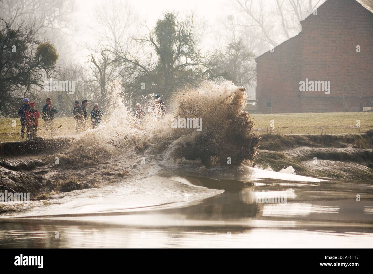 The Severn Bore breaking against the river bank at Weir Green, Gloucestershire UK Stock Photo