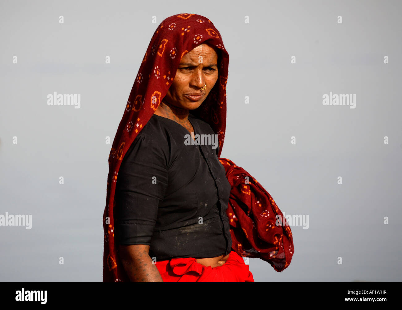 Indian Tribal fisherwoman with neck and arms tattoos at Vanakbara Fishing Village, Diu Island, Gujarat, India Stock Photo