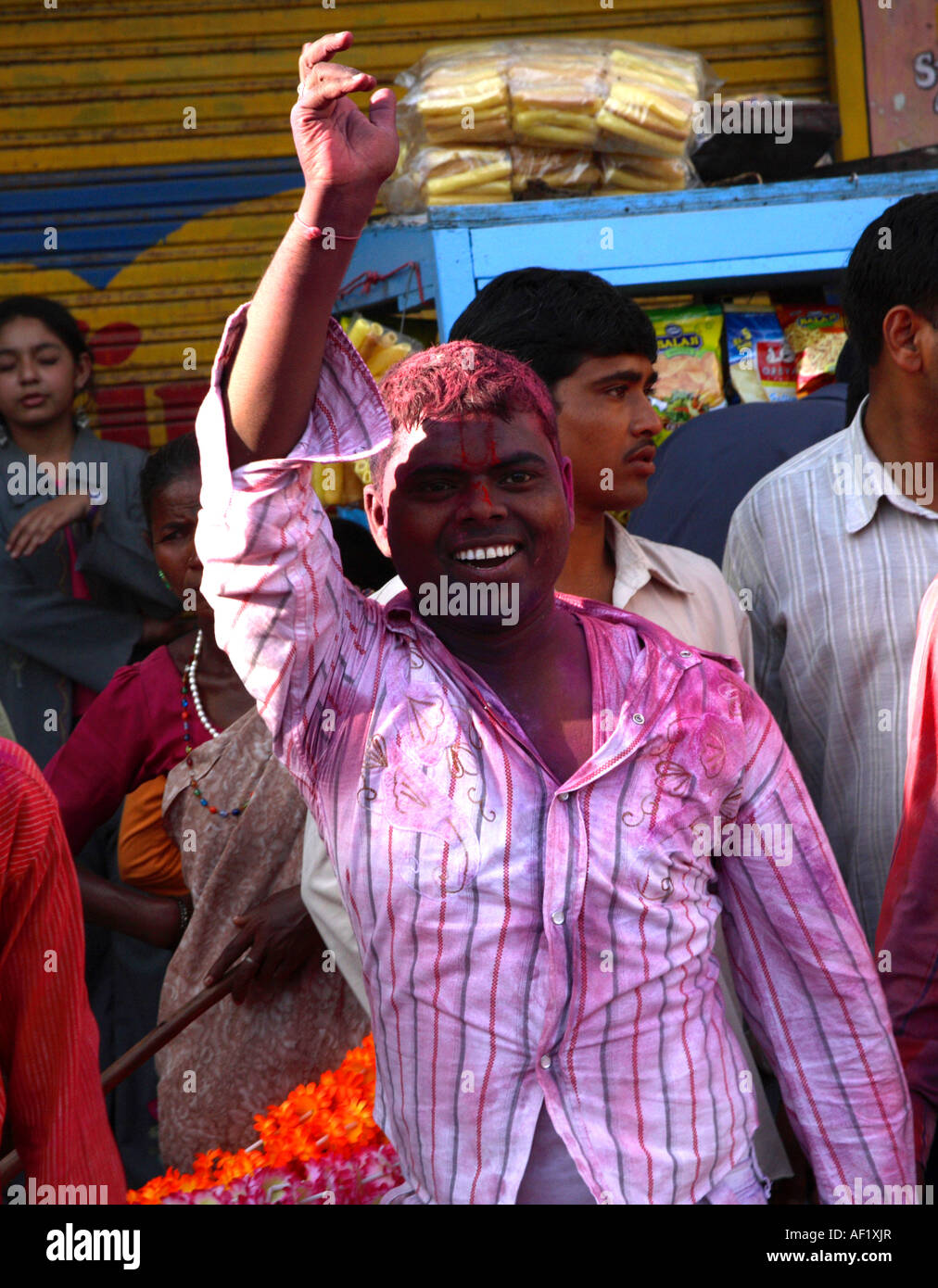 Indian male with clothes and hair coloured in pink paint celebrating holi spring festival of colours, Dwarka, Gujarat, India Stock Photo