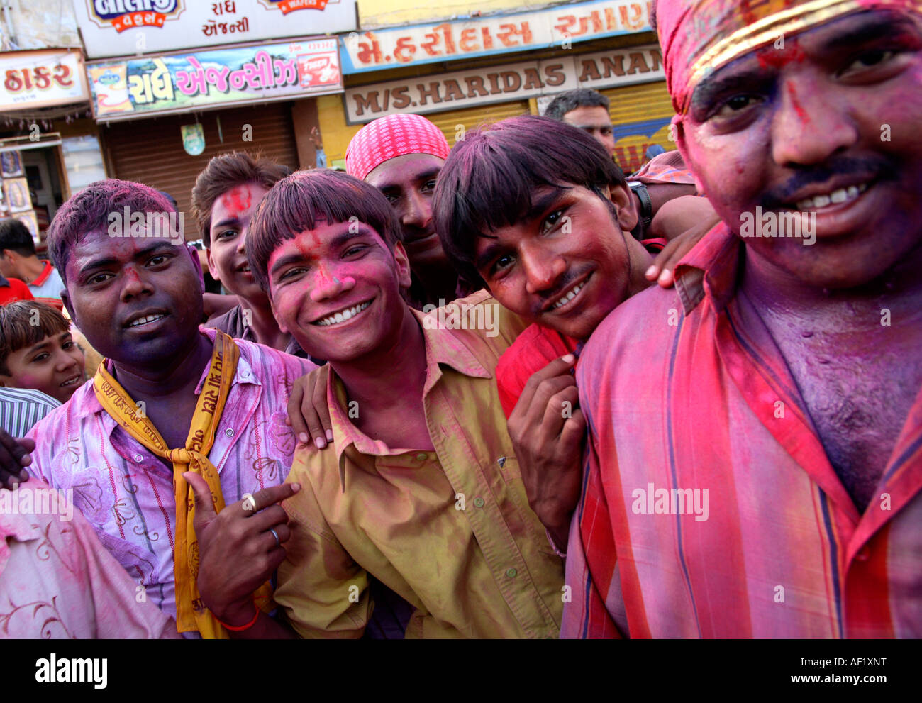 Indian males covered in pink paint celebrating holi spring festival of colours, Dwarka, Gujarat, India Stock Photo