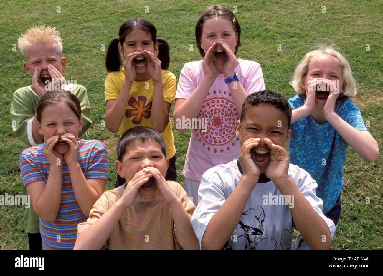 group-of-seven-children-yelling-together-AF1Y48.jpg