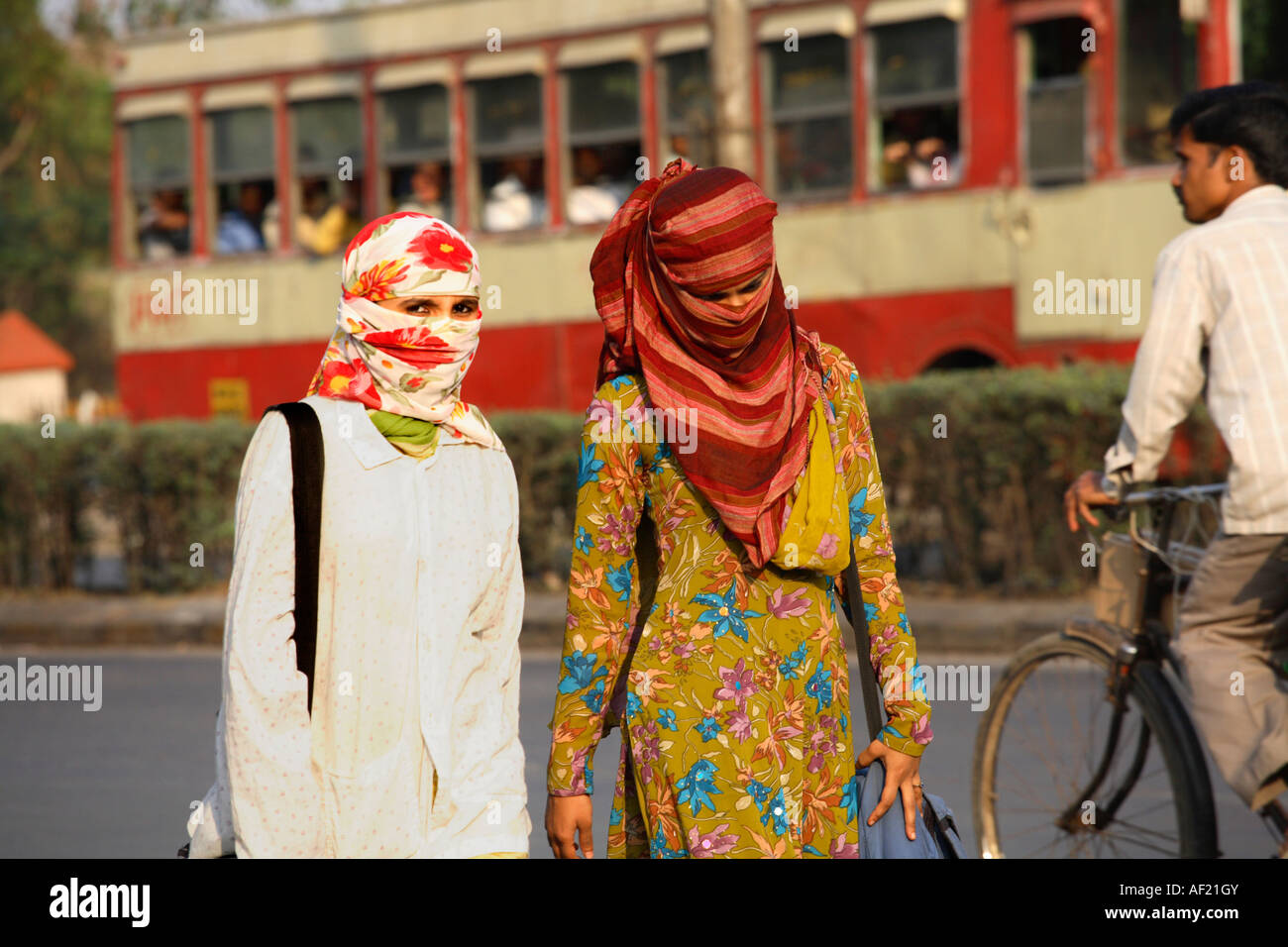 Two Indian women wearing head scarves concealing their faces walking  through street, Pune, India Stock Photo - Alamy