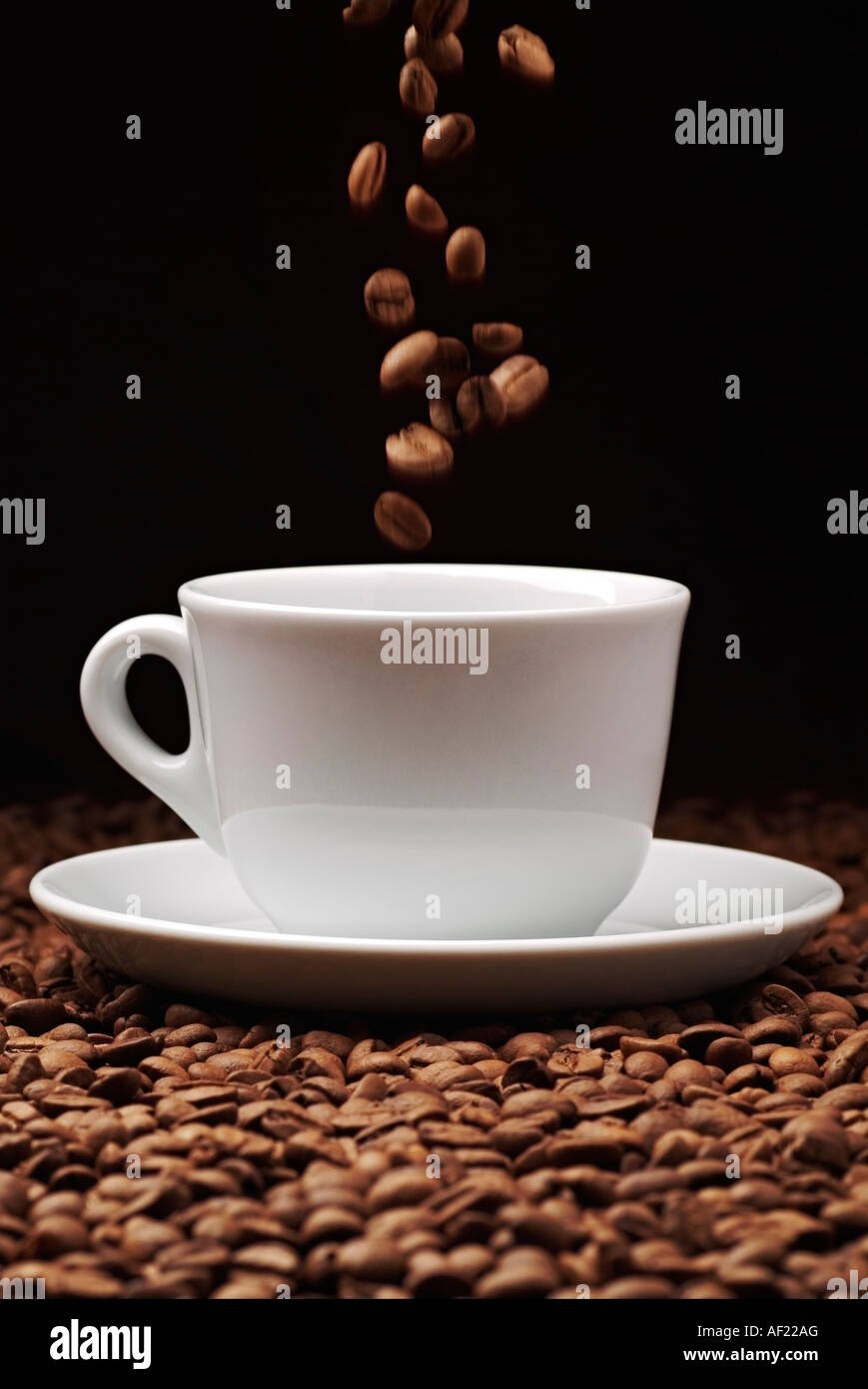 Coffee Beans Falling into a Coffee Cup Stock Photo - Alamy