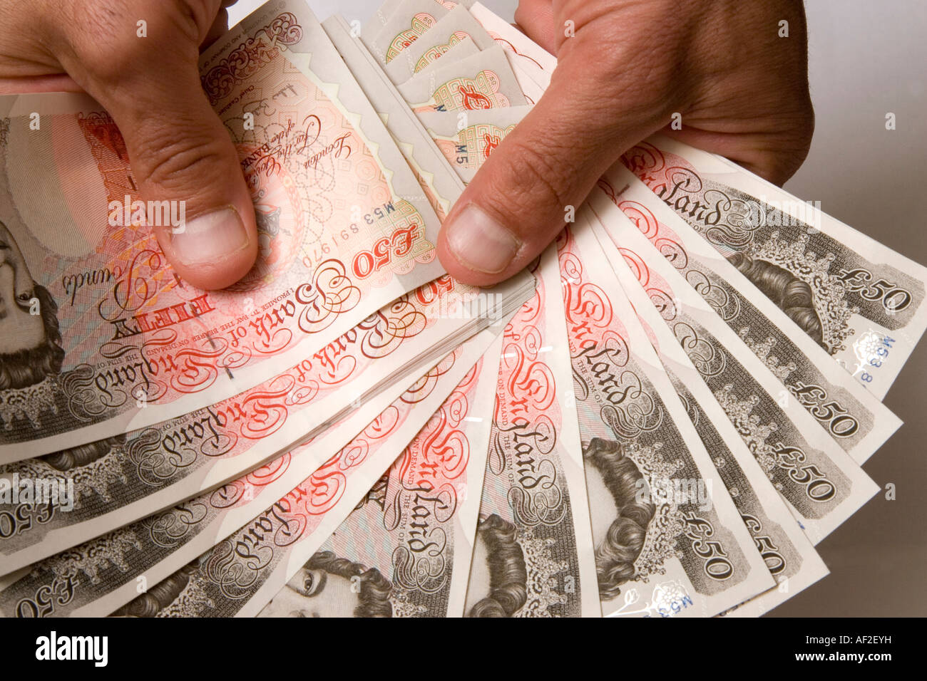 Hands holding fifty pound notes in a fan 50 Stock Photo