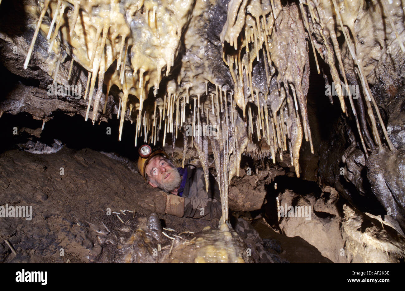 Caver Geoff Workman in Great Expectation a newly discovered cave North Yorkshire Stock Photo