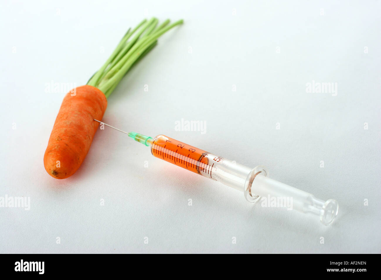 a carott and an injection Stock Photo - Alamy