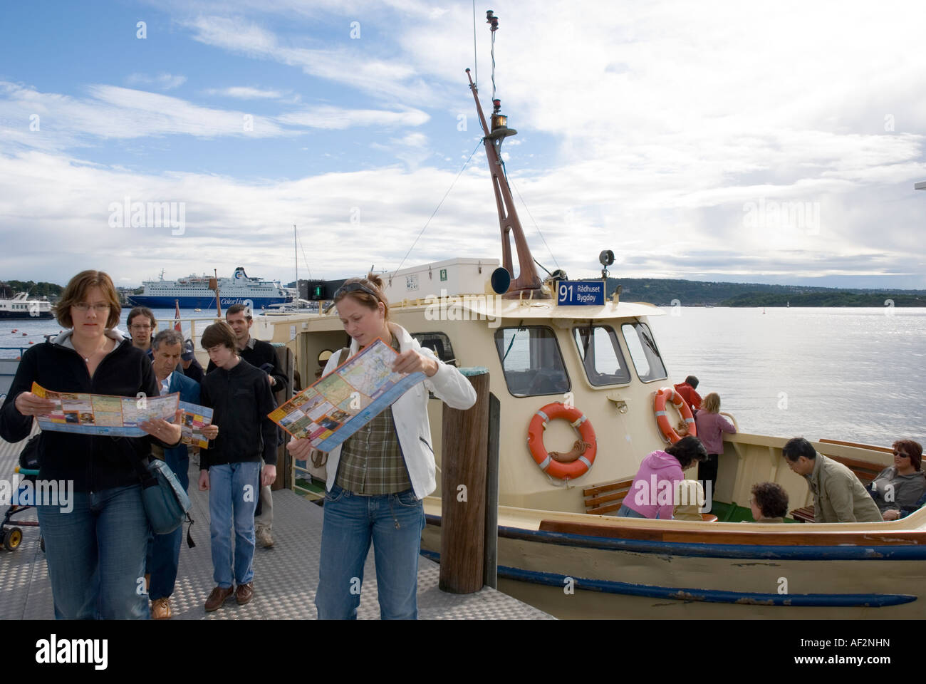 Tourists looking at maps after Oslo Harbour Ferry crossing to Bygdoynes Stock Photo